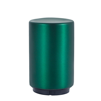 Green cylindrical portable beer bottle opener on a white background