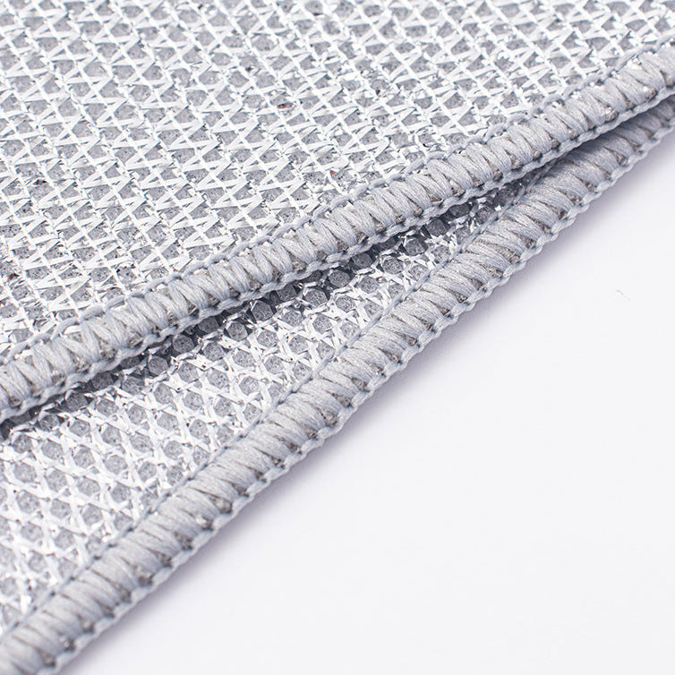 Close-up of a textured gray wire dishcloth with a white background