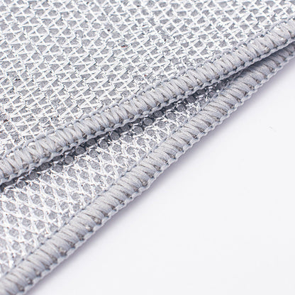 Close-up of a textured gray wire dishcloth with a white background