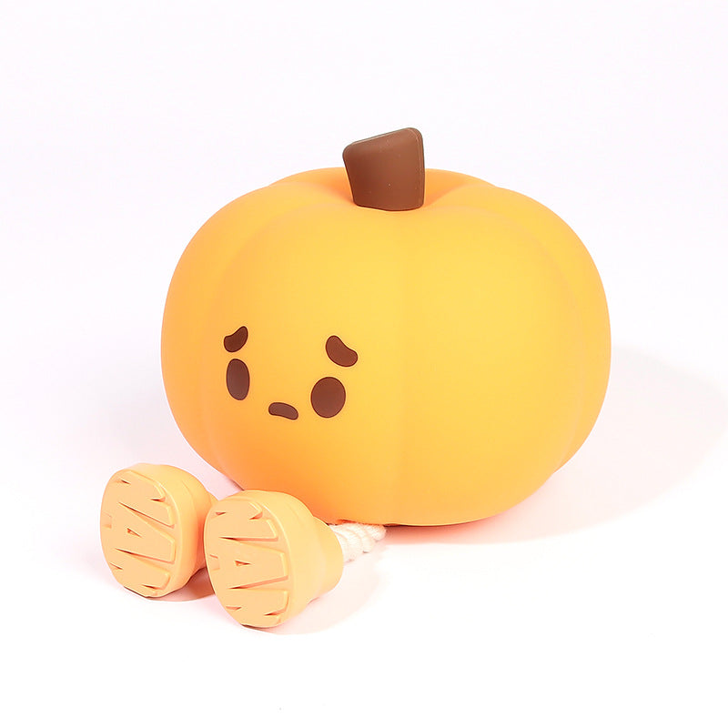 Pumpkin Night Light with a sad face on a white background