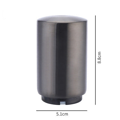 Metallic cylindrical portable beer bottle opener with dimensions on a white background