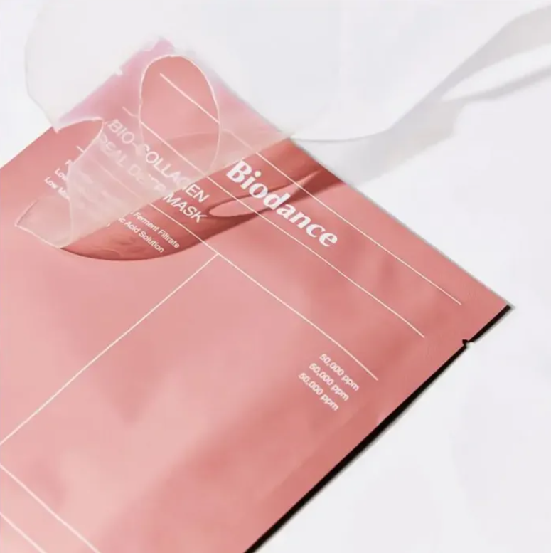 Pink sheet mask with 'Biodance' branding on a white background