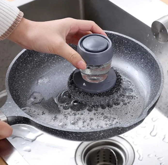 Person using a kitchen 
soap dispenser steel brush