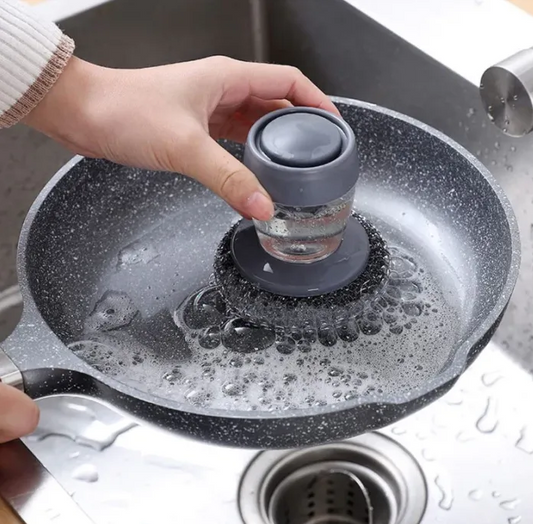 Person using a kitchen 
soap dispenser steel brush